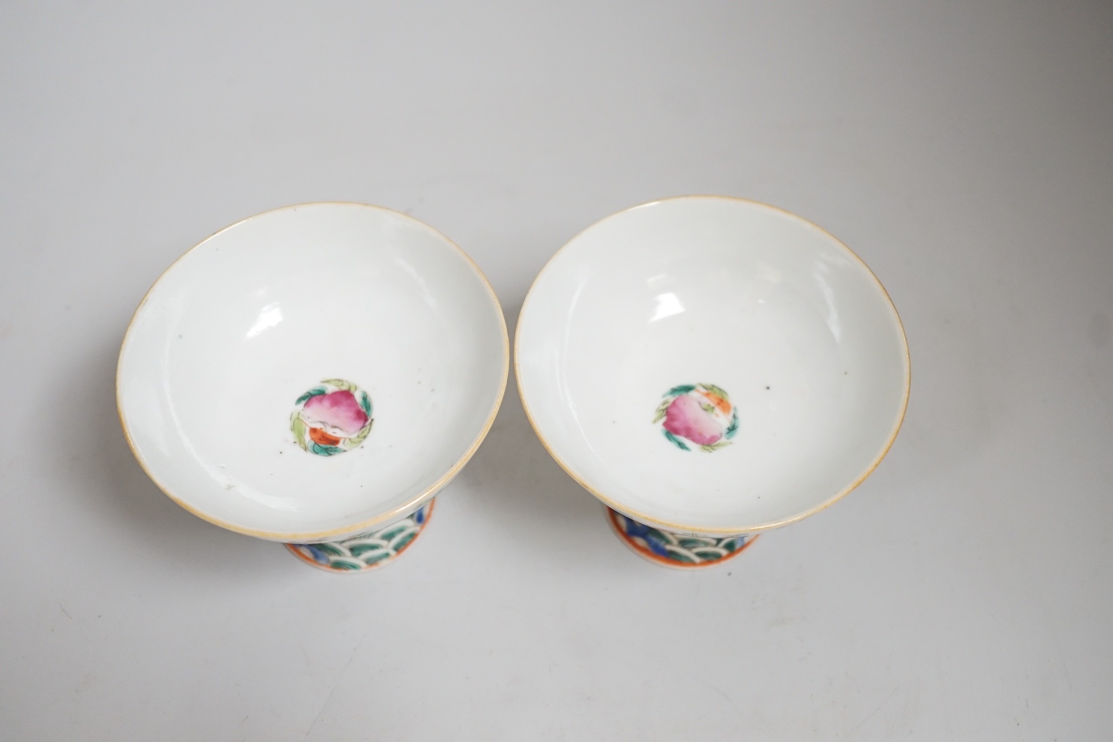 A pair of 19th century Chinese stem cups with four flower design, 9cm